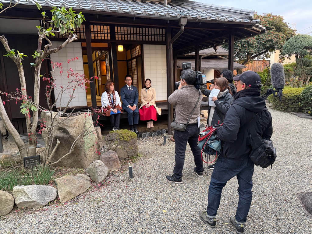 J:COM北河内「長っと散歩」の撮影をしているもりぐち歴史館長、谷水J:COM北河内局長、タレントのみちごえゆうさん