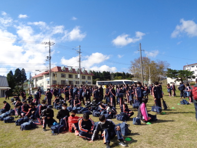 芝生のある広場に生徒たちが集まっている様子を写した写真