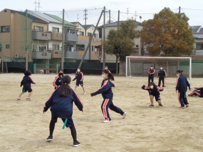 中央に赤いタグをつけて走る女子生徒、手前に青いタグをつけて両手を広げている女子生徒が写っている写真