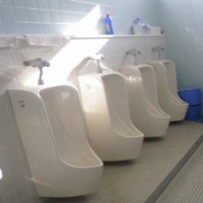 トイレに男性用小便器が4つ並んでいる写真