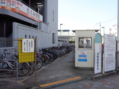 出入口に向かって右に大日駅北第2自転車駐車場と書かれた看板と注意書きが記された看板が立っている、大日駅北第2自転車駐車場の写真