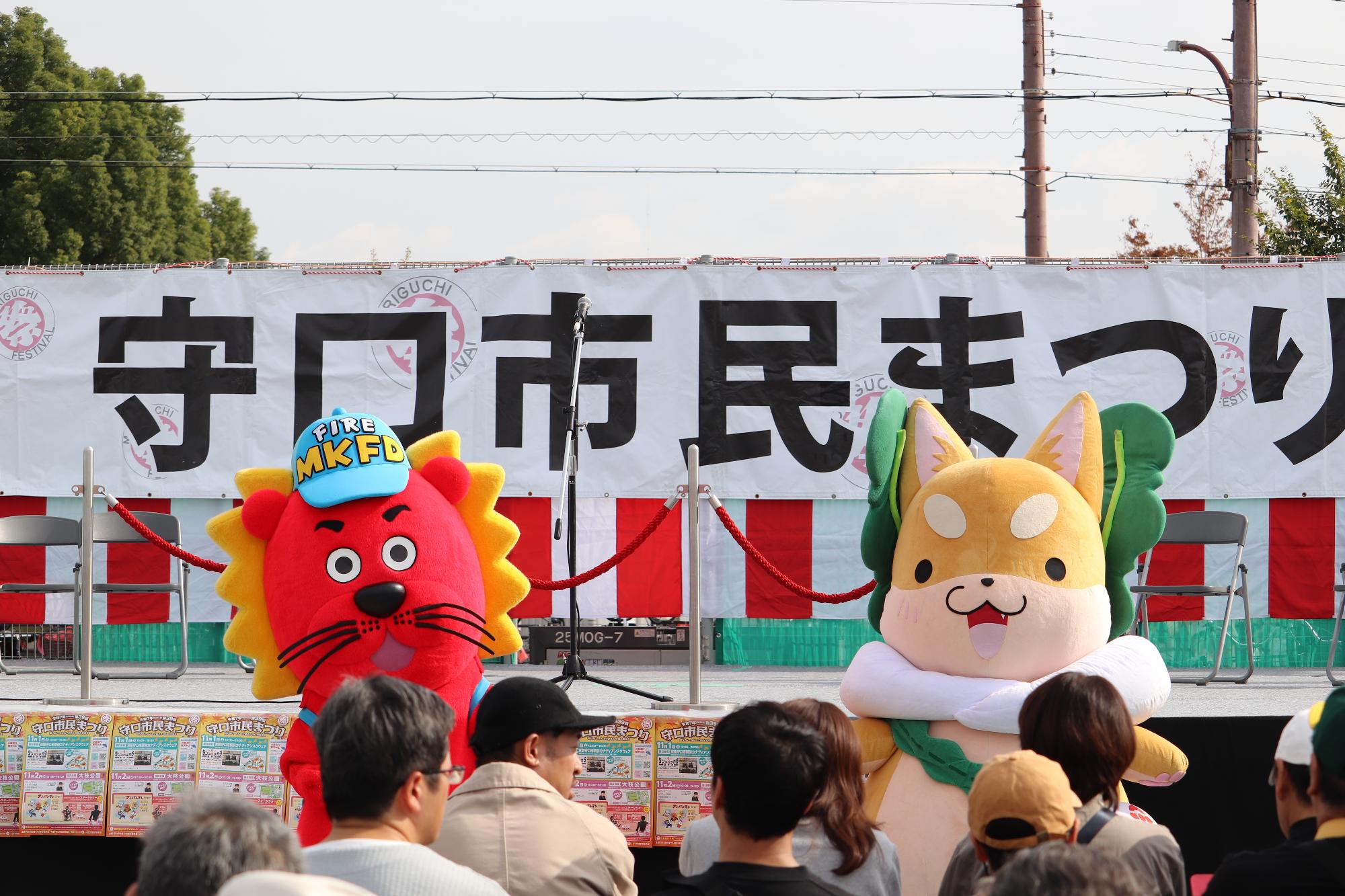 もり吉とレンダイオンが舞台にいる